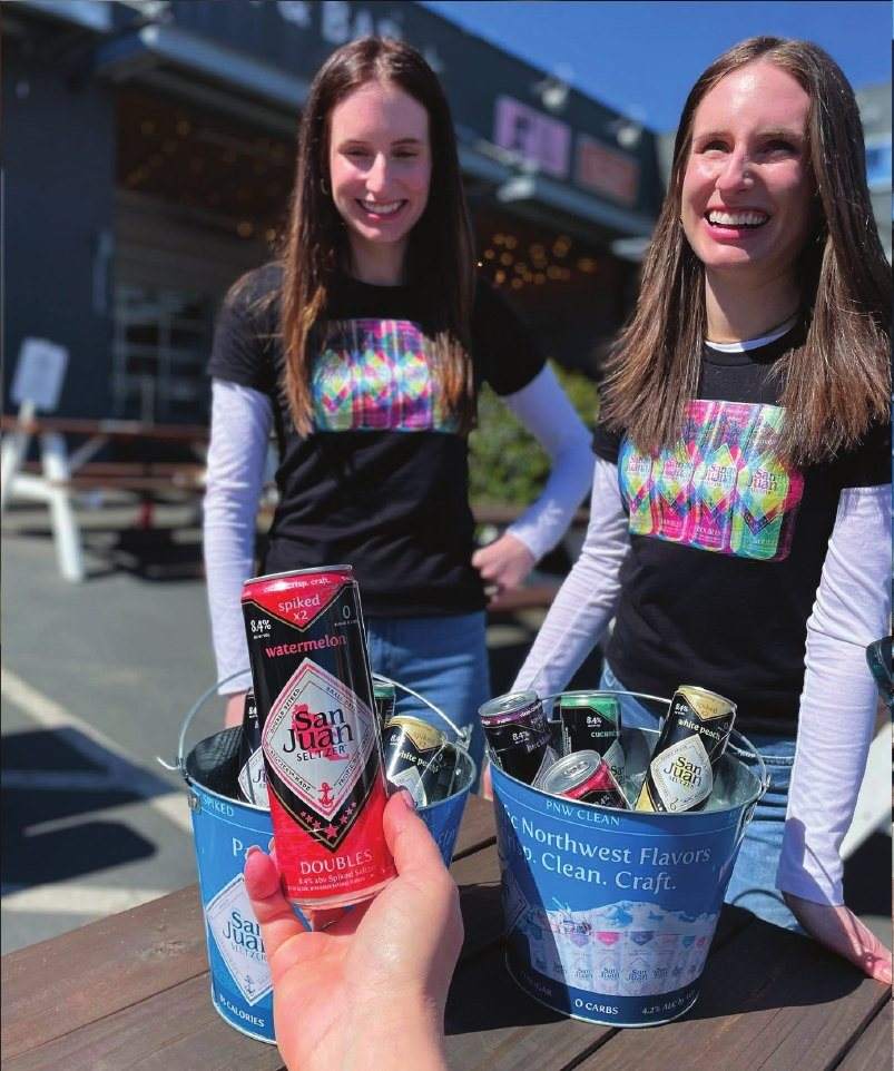 Staff in branded shirts handing out cans